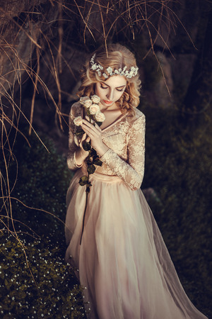 The beautiful countess in a long pastel dress  is walking in a green forest full of branches, elf,  Princess in vintage dress, the queen of the forest,fashionable toning creative computer colorsの写真素材