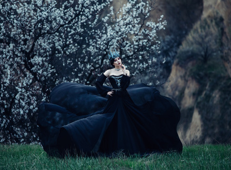 A dark evil queen sneaks through the blooming gardens, white wild Princess, vampire, thigh toning, creative color, dark bohemianの写真素材