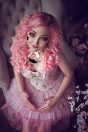 the girl broken porcelain doll girl with pink hair lの写真素材