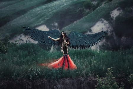 Black Angel. Pretty girl-demon with black wings. An image for Halloween. Image of an old book of fairy tales. Fashionable toning creative computer colorsの写真素材