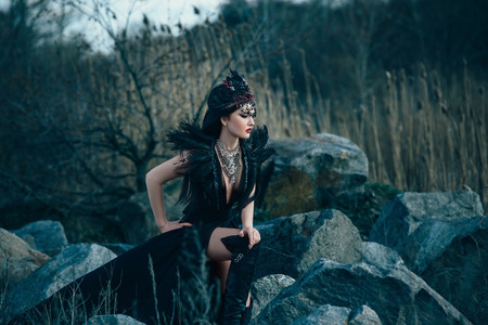 dark evil queen sneaks through the stone canyon at cosplay movie snow white, wild Princess , vampire , hip toning , creative color,dark bohoの写真素材