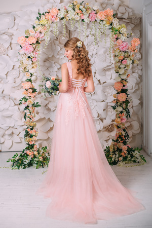 Bride in a gently pink dress, against the background of a wedding arch. Creative colorsの写真素材