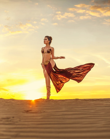 Cosplay Leia Organa Solo. A beautiful, sexy girl walks in the desert. Creative colorsの写真素材