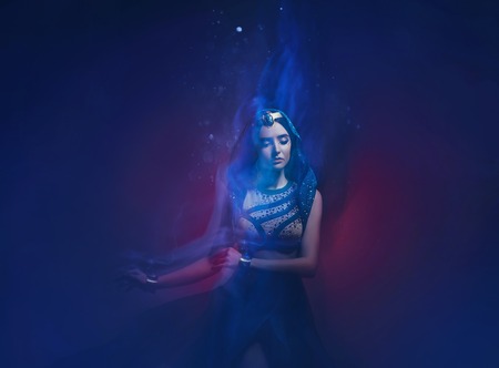 A girl in oriental attire, Queen of the storm. Princess Jasmine. The background is a twist and a...