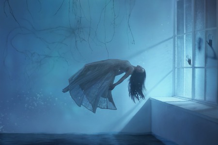 A ghost girl with long hair in a vintage dress. Room under water. A photograph of levitation resembling a dream. A dark Gothic interior with branches and a huge window of flooded light. Art photoの写真素材