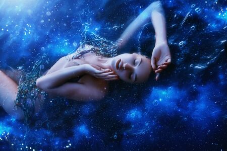 Artistic processing. young relax Sleep dream Beauty. Concept sexy sky woman cosmos harmony energy star radiance flat. image goddess world nature resting one girl. Bright color black blue glitter shineの写真素材