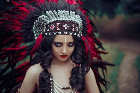 Portrait girl beautiful face art native american creative warrior combat makeup. Indian woman hunter...