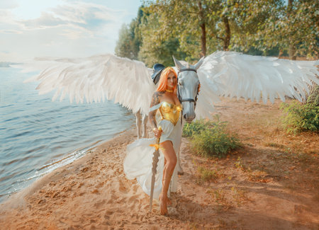 Art photo real people Fantasy woman warrior queen hand strocking white horse with wings pegasus animal. goddess girl sexy princess holds magic sword in hands. summer nature water river sea lake riverの写真素材