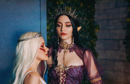 Art fantasy portrait fairy evil insidious revenge woman vampire sexy queen with punishes captive sad girl princess. Halloween creative makeup close up wound scars blood on face. Medieval ancient room.の写真素材