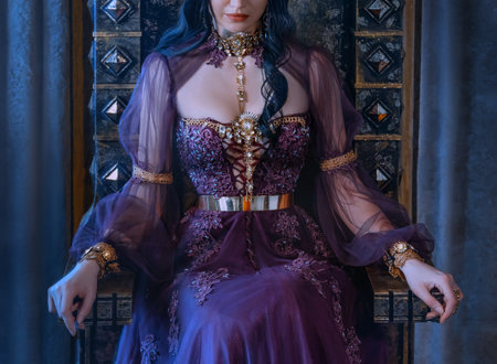 Close-up fantasy portrait woman queen sits on antique royal throne. No face. Beautiful vintage majestic luxury medieval tulle long dress. Gold jewelry, necklace, brooch. Backdrop gray curtains drapesの写真素材