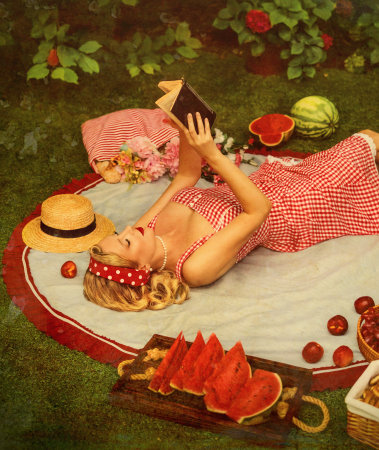 old-fashioned photo happy retro lady blonde hair pin up old style red lips dress smiling face woman lies on blanket hands holding book reading novel enjoying rest picnic garden park. Vintage 30s girlの写真素材