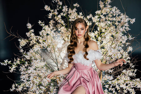 art photo real person beauty face elf woman queen sitting on flowering throne, sexy fantasy girl princess long blonde hair, pink dress spring tree night garden flowers goddess nature magic lightの写真素材
