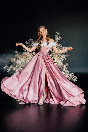 art photo real person beauty face elf woman queen sitting on flowering throne trees, sexy fantasy girl princess fashion model posing in stylish pink dress spring tree night garden flowers magic lightの写真素材