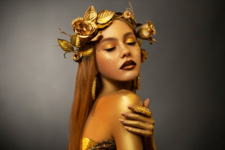 Fantasy portrait woman autumn greek goddess. golden skin body. Girl queen in wreath crown flowers gold roses. Sexy face metal glitter art makeup. Artistic photo. Girl glamour princess. Fashion modelの写真素材