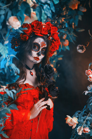Close-up beauty face woman sugar skull make-up art paint, black rose flower. eyes lips red dress crown with roses flowers on head. Sexy girl Calavera in dark black night leaves garden trees blue fog.の写真素材