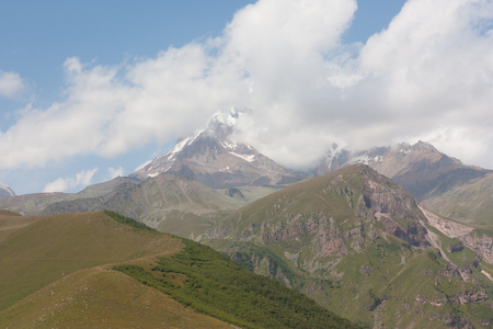 Kazbek is an extinct volcano with a height of 5033 m located in the Eastern part of the Central Caucasus, on the border of Russia and Georgia. The view from the village of Stepantsminda, Georgiaの写真素材