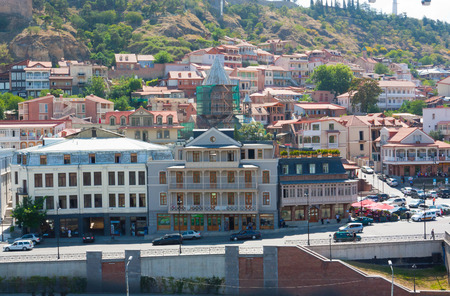 Tbilisi, Georgia-August 07, 2013: Embankment of the Mtkvari river and historic Sololaki district in...