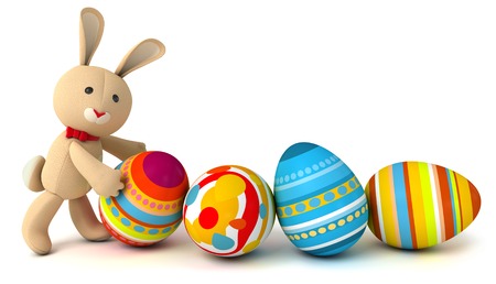 Funny toy rabbit pushes painted Easter eggs. Isolated on white background. 3d renderの写真素材