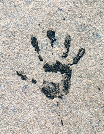 Black Handprint. The imprint of a human hand on the ground. Close-upの写真素材
