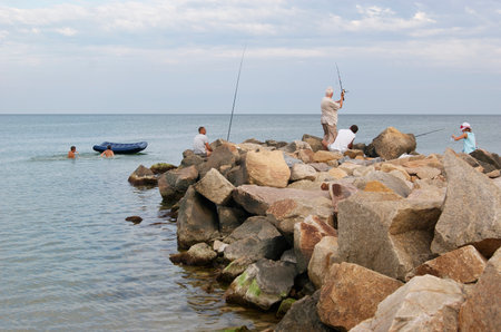 Fishermen to fish standing on the rocksのeditorial素材