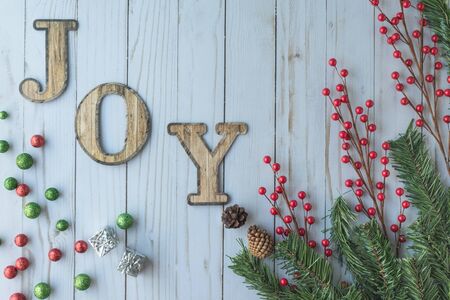 Joy Holiday Christmas with berries red over rustic white wood.の写真素材