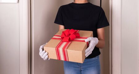Hands holding box, with rubber gloves Home delivery during virus outbreak, Respecting health standards.の写真素材