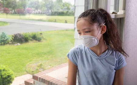 Teen girl during pandemic using face mask . 
Copy space.の写真素材