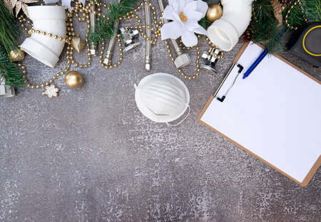 Christmas and New Year holiday decoration with face mask, construction tools on the wooden background top view. Plumber Christmas.の写真素材