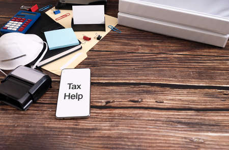 Tax Concept during coronavirus with Office folder with inscription Taxes on the wooden desk. Space for text.の写真素材