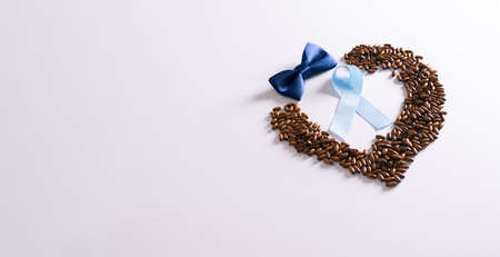 Light blue ribbons, heart and Bow tie on white background with empty space for text. Prostate Cancer Awareness, November Men health awareness, International Men's Day. selected focus.の写真素材