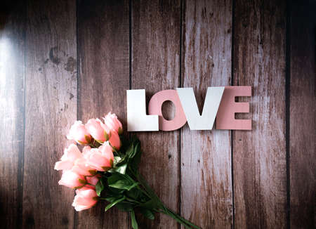Top view of pink flowers on wood background for mothers, Valentine's Day, love for Mother's or Happy Women's day.の写真素材