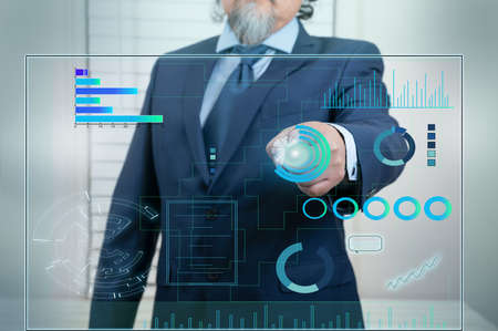 A businessman works on a Touchscreen Interface with Technology in business data. Futuristic style,...