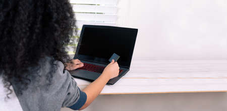 woman holding credit card, sitting at desk with laptop, technology, survey and online payment...