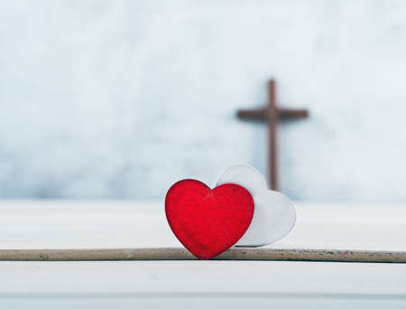 wooden cross and Two red and white hearts on wood background, GOD IS LOVE concept.の写真素材