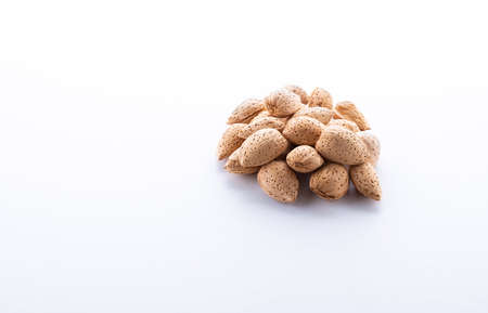 Heap of Almond nuts isolated on white background, close-up.の写真素材