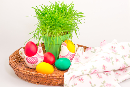 Traditional Easter decoration with colorful eggs, grass and towelの写真素材
