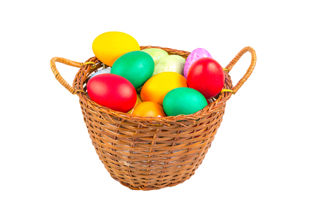 Wicker basket which filled with colorful Easter eggsの写真素材