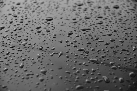 drop water in glass on black and white backgroundの写真素材