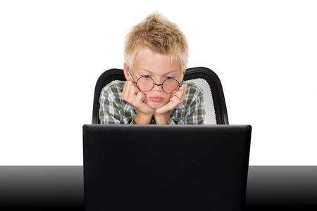Emotions on a face of the boy during the work with the laptopの写真素材