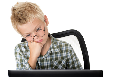 Emotions on a face of the boy during the work with the laptopの写真素材