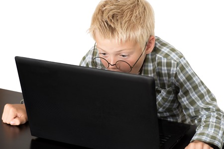 Emotions on a face of the boy during the work with the laptopの写真素材
