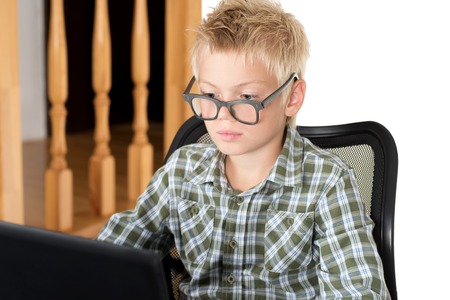 Emotions on a face of the boy during the work with the laptopの写真素材