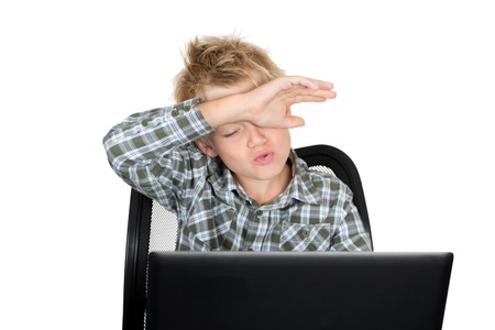 Emotions on a face of the boy during the work with the laptopの写真素材