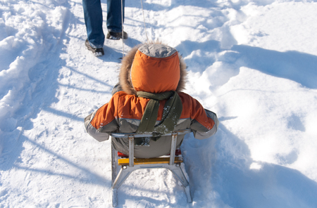 Little boy having fun in the snowの写真素材