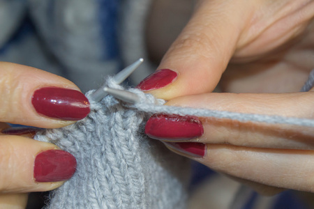 Close-up of hands knitting. Detail of the hands of an crocheting. People and needlework concept -...