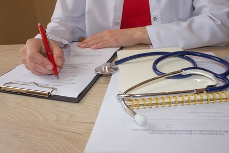 Doctor working in hospital writing a prescription. Healthcare and medical concept. Medicine doctor's working tableの写真素材