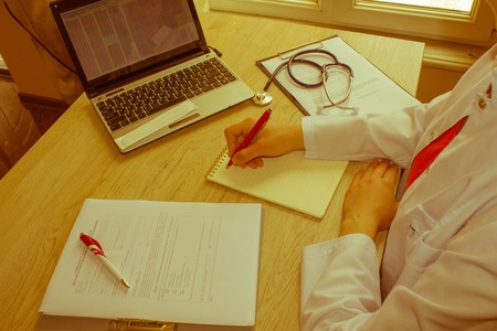 Shot of female medical doctor's hands. Healthcare and medical concept. Medicine doctor's working table - Retro colorの写真素材