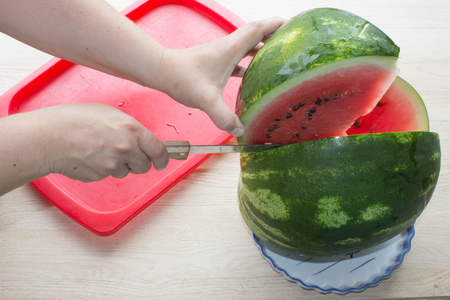 single watermelon cut on wood table at natural background. summer food conceptの写真素材