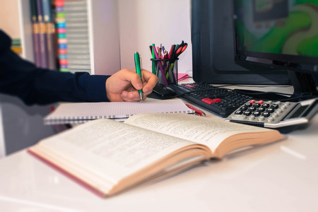Close up view of bookkeeper or financial inspector hands making report, calculating or checking...