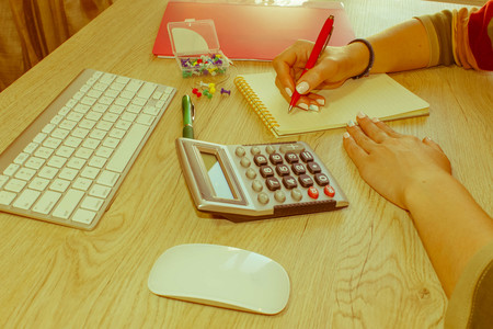 Savings, finances, economy and home concept - Female with calculator, Female holding pens, papers, notes in documents  - Retro colorの写真素材